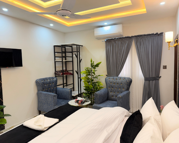 A Hotel Room With A Cozy Bed And Photo Pillow at The Decent Luxury Guest House