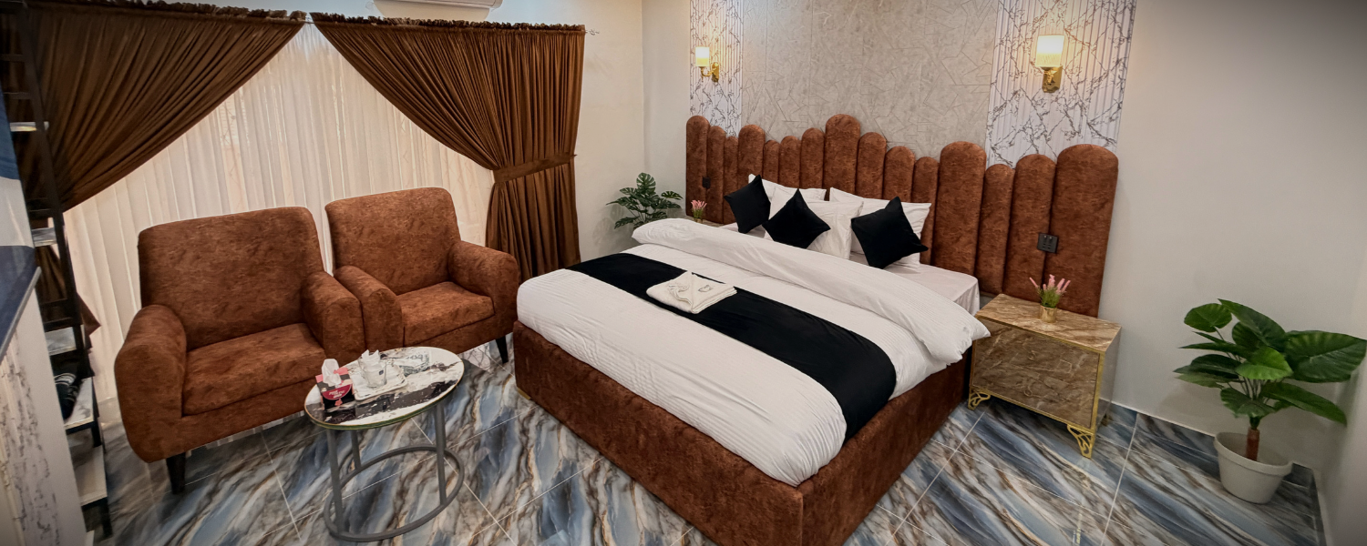 A hotel lobby with elegant decor, comfortable seating, and a reception desk at The Decent Luxury Guest House